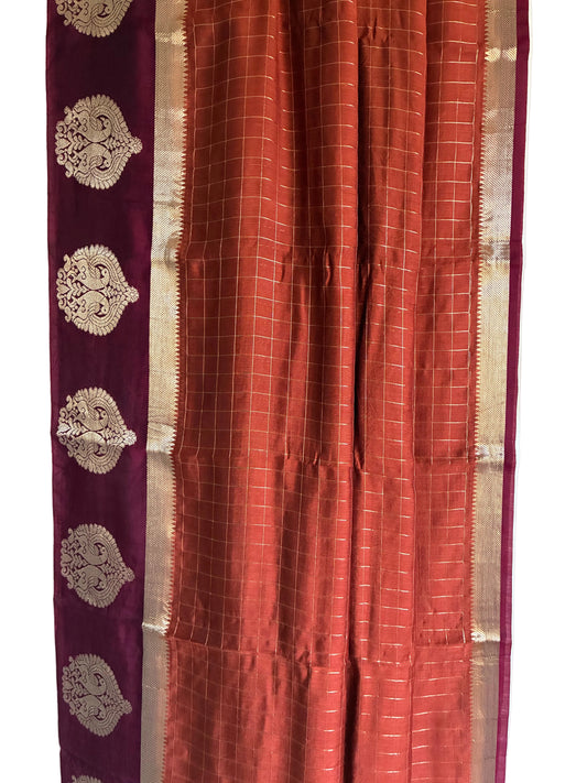 Close up of warm rust orange saree weave featuring fine grid check pattern detail