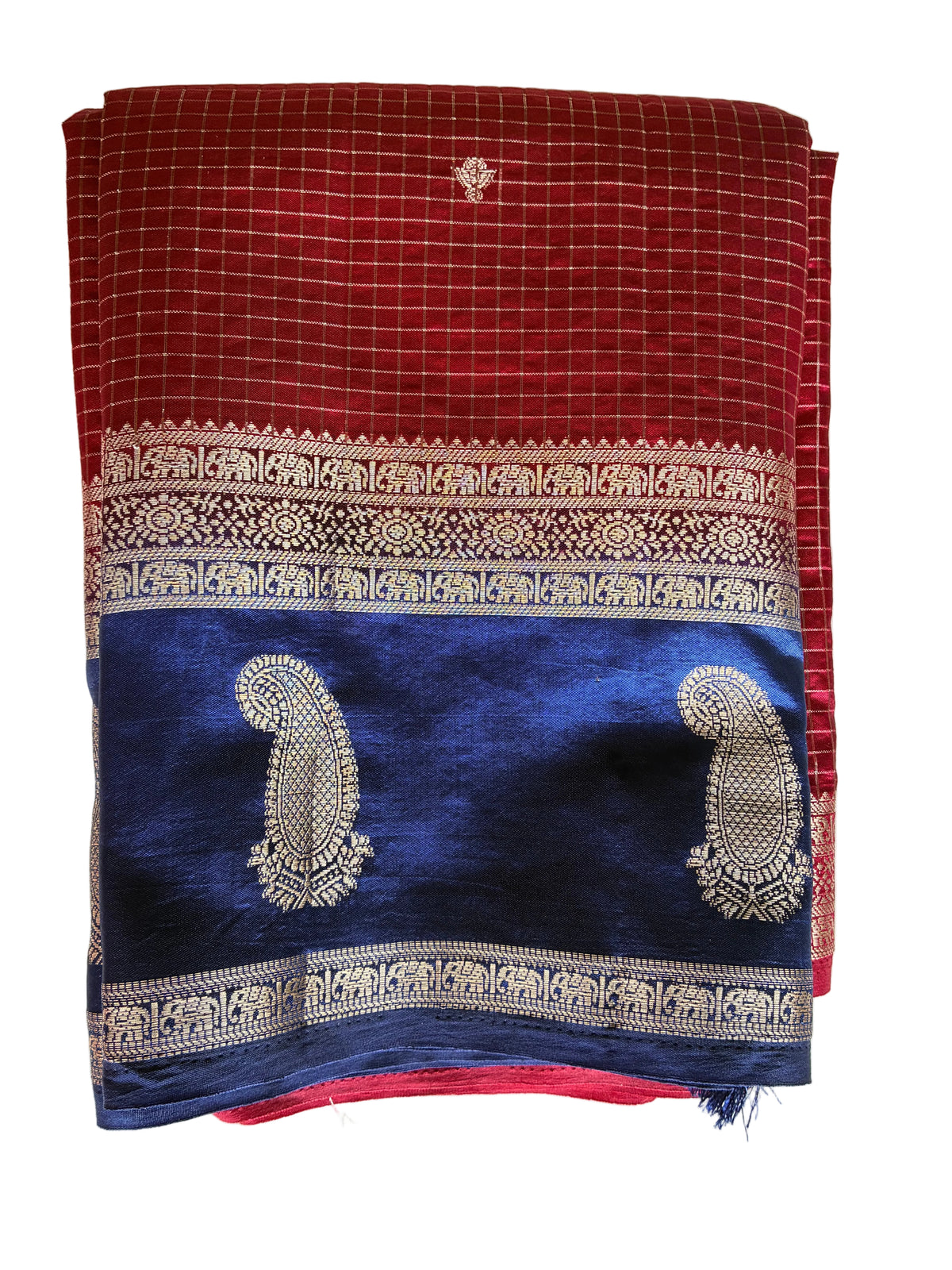 Neatly folded light comfortable red checked saree showcasing vibrant blue contrast border