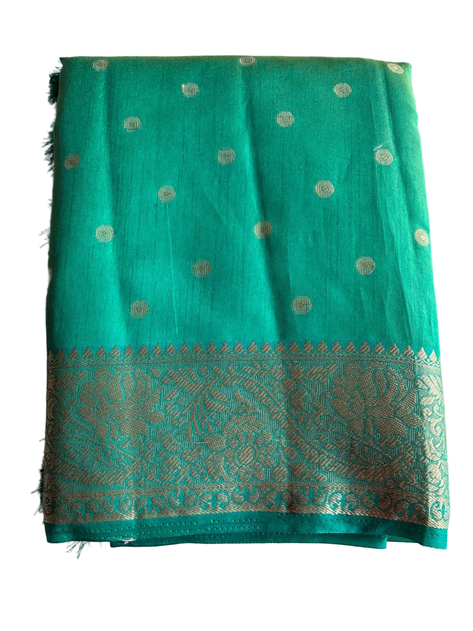 Neatly folded light comfortable teal blue saree showcasing gold butti weave and floral border detail