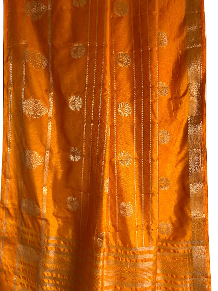 Close up of soft breathable yellow fabric featuring gold floral weave and fine vertical stripe patterns