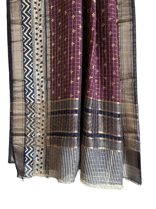 Detailed view of contrasting striped pallu with geometric border detailing and tassel finish