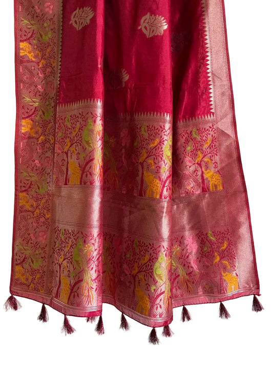 Detailed view of rich red saree pallu with pink and green accents and red tassels