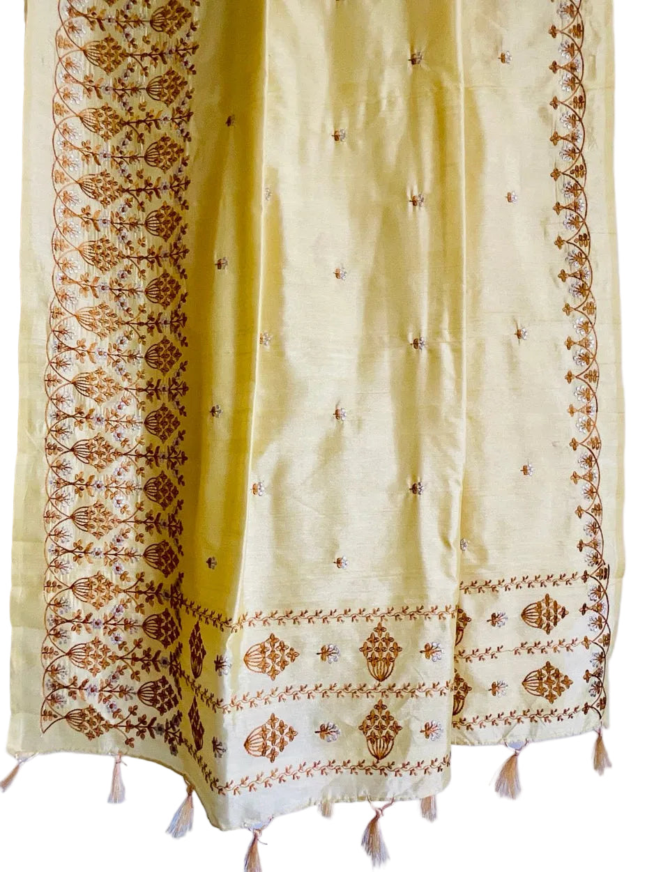 Yellow saree with brown embroidery and tassels on a blue background