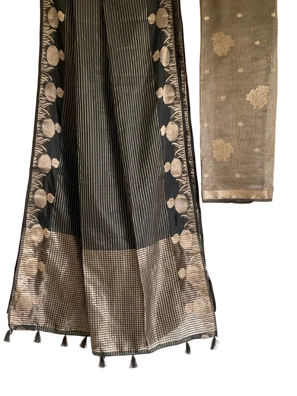 Black and white patterned fabric with tassels on a plain background