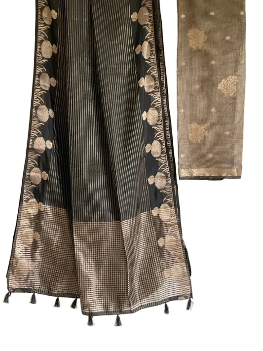 Black and white patterned fabric with tassels on a plain background