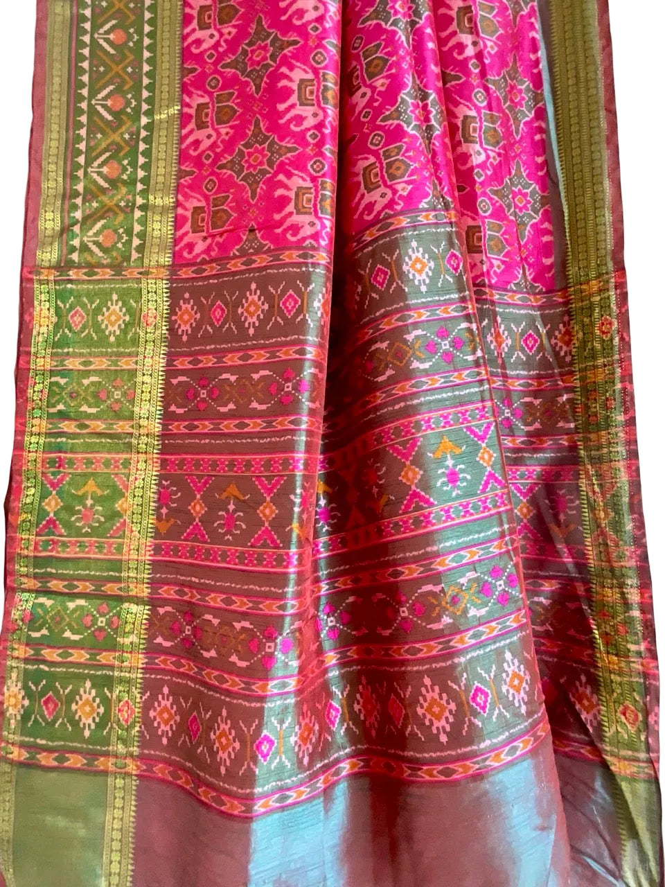 Traditional patterned saree with pink, green, and brown colors on a plain background