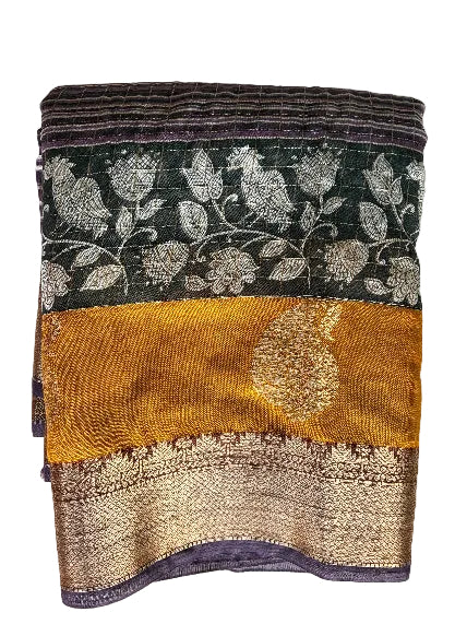 Neatly folded light comfortable purple and mustard Kalamkari Assam silk saree showing gold border