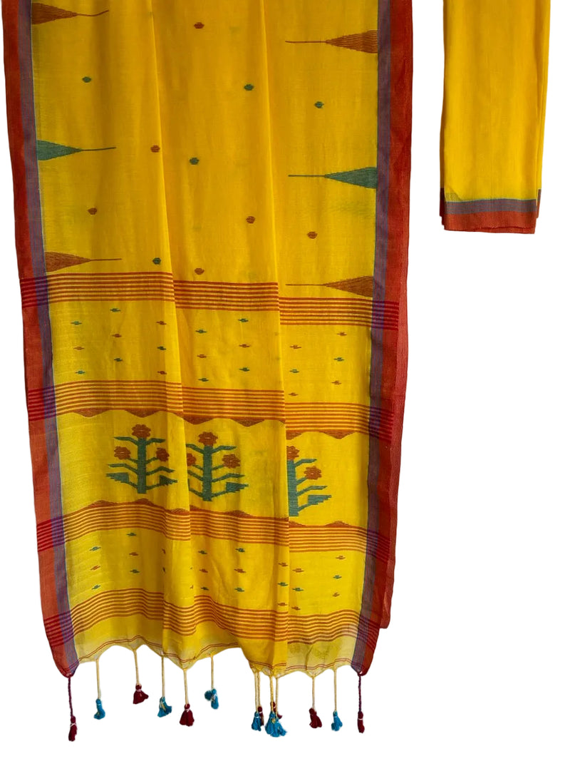 Yellow fabric with red and green patterns draped over a white wall