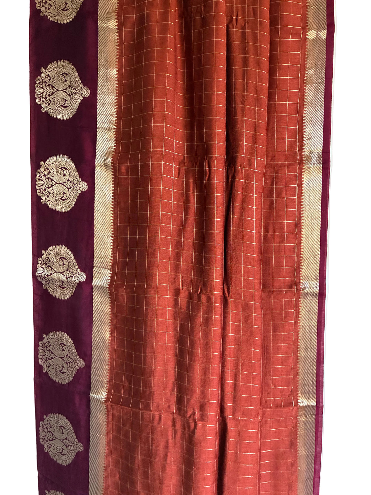 Close up of warm rust orange saree weave featuring fine grid check pattern detail