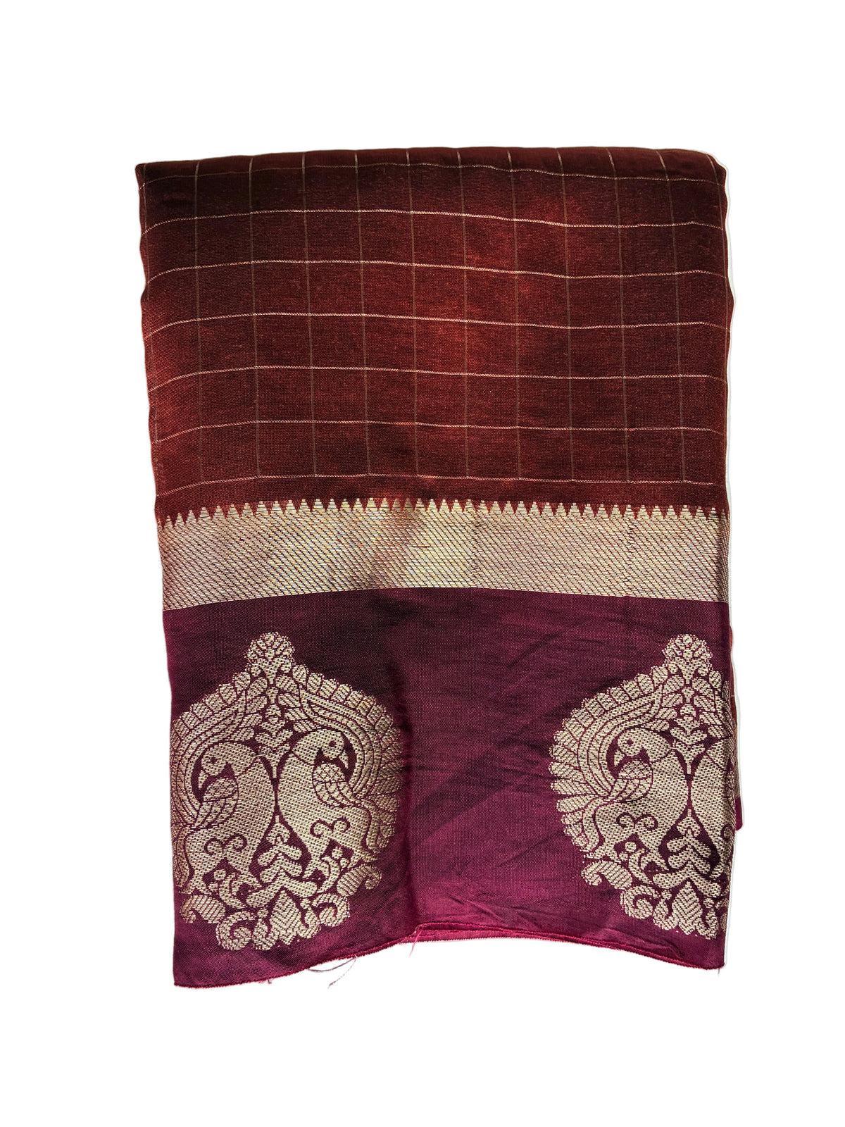 Neatly folded rust orange checks saree showing warm autumn tone and crisp grid layout