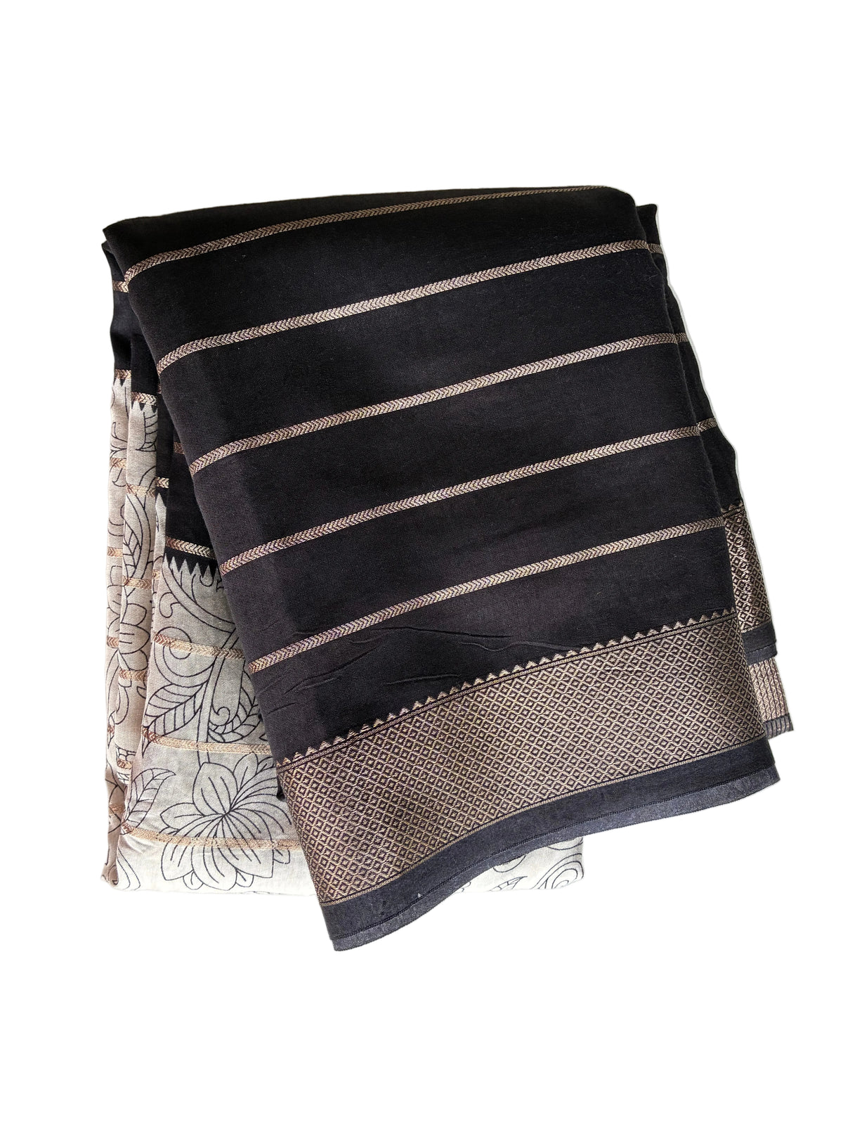 Neatly folded black Kalamkari print saree showing fine gold stripes and lustrous golden border detail