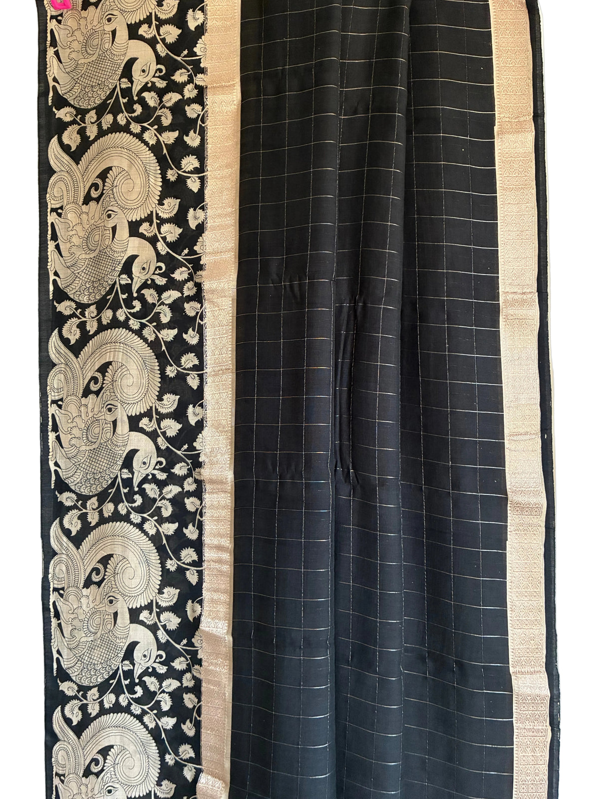 Lightweight soft Assam silk saree in black check pattern with ivory peacock pallu full drape. close up of aariyaa sarees
