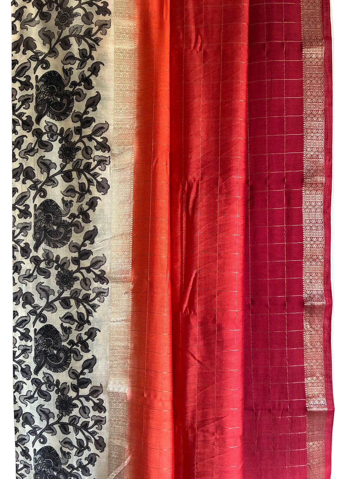 Close up of soft breathable Assam silk weave with red and orange with gold checks