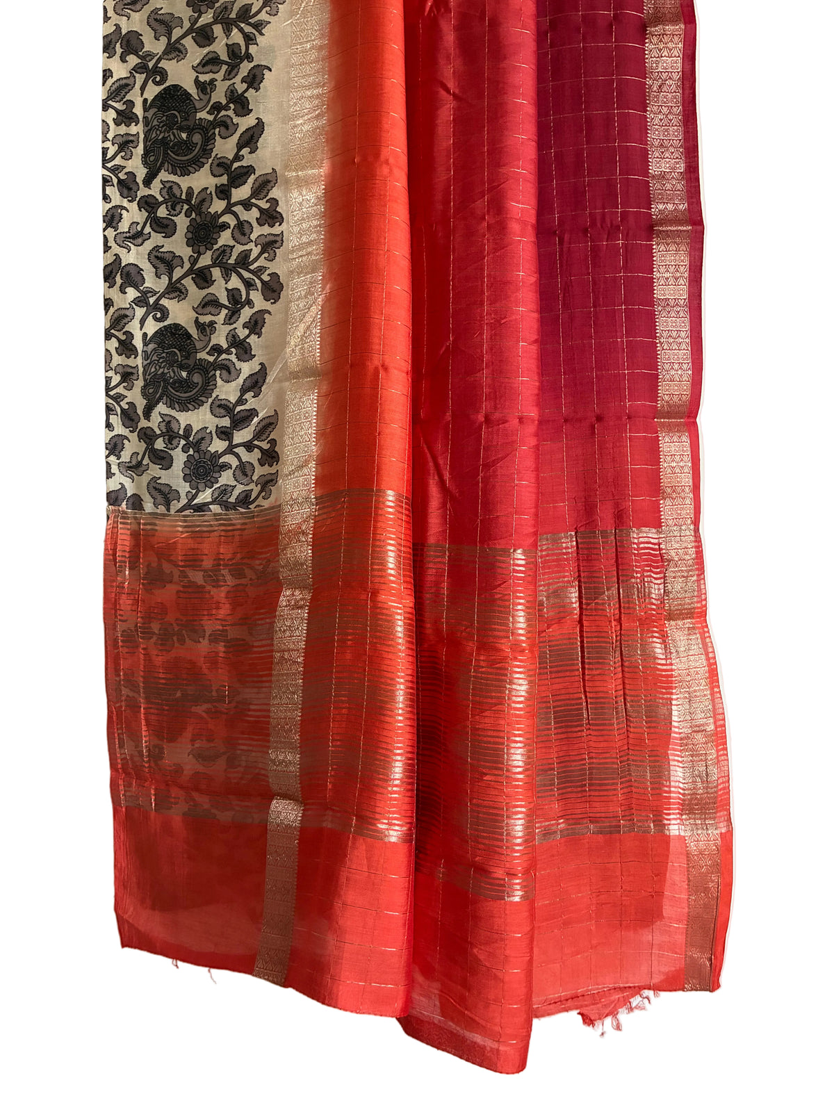 Detailed view of rich Assam silk saree pallu featuring black Kalamkari florals and paisley motifs