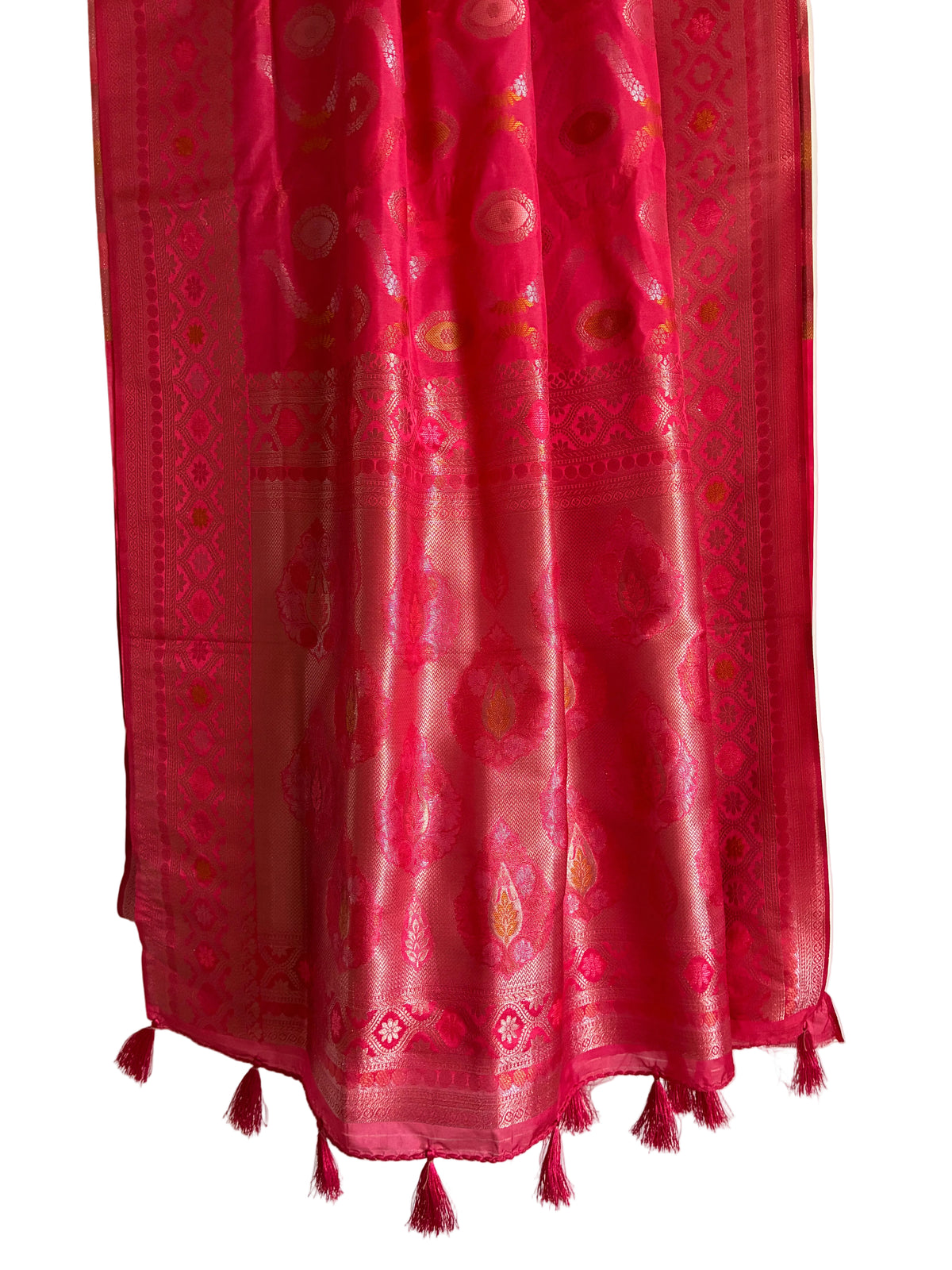Detailed view of rich bright pink red saree pallu with ornate Banarasi detailing and matching tassels