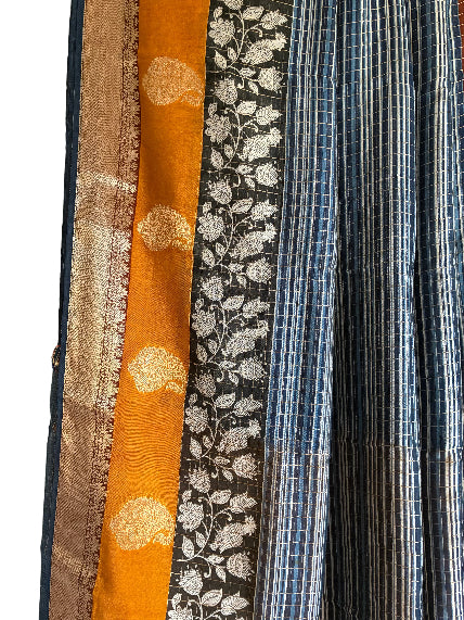 Close up of soft breathable blue Assam silk fabric with fine stripes and gold-toned detailing