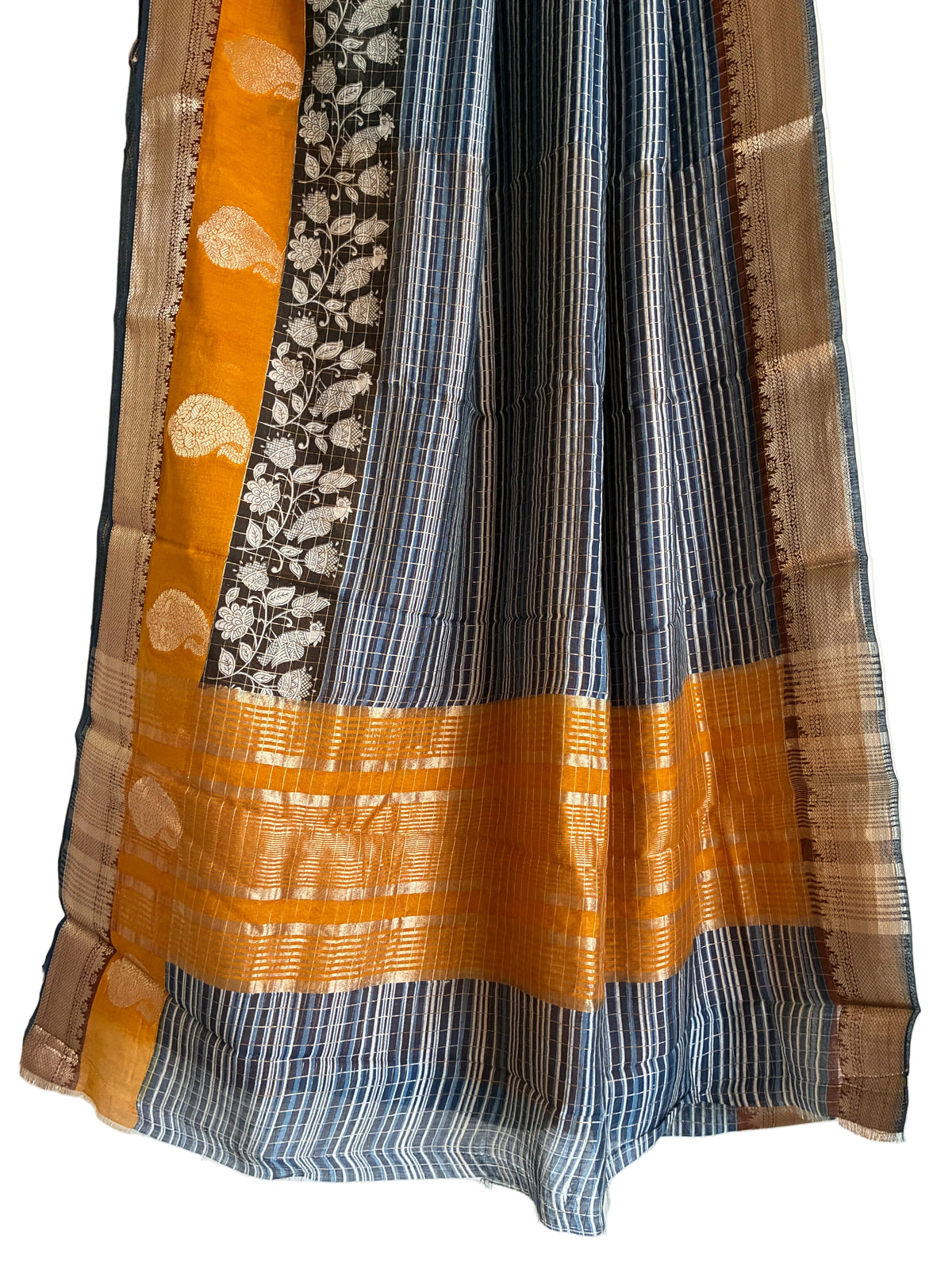 Detailed view of rich Assam silk saree pallu featuring black Kalamkari floral vines and mustard accents for artistic look 