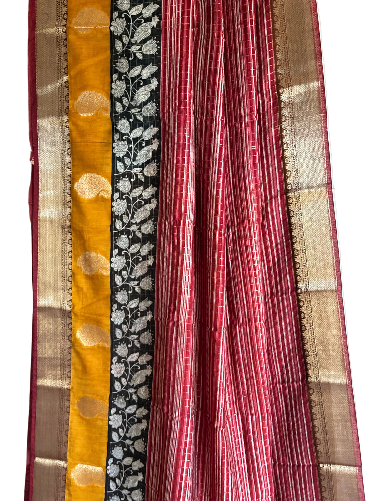 Close up of soft breathable red Assam silk weave featuring fine stripes and gold-toned motifs