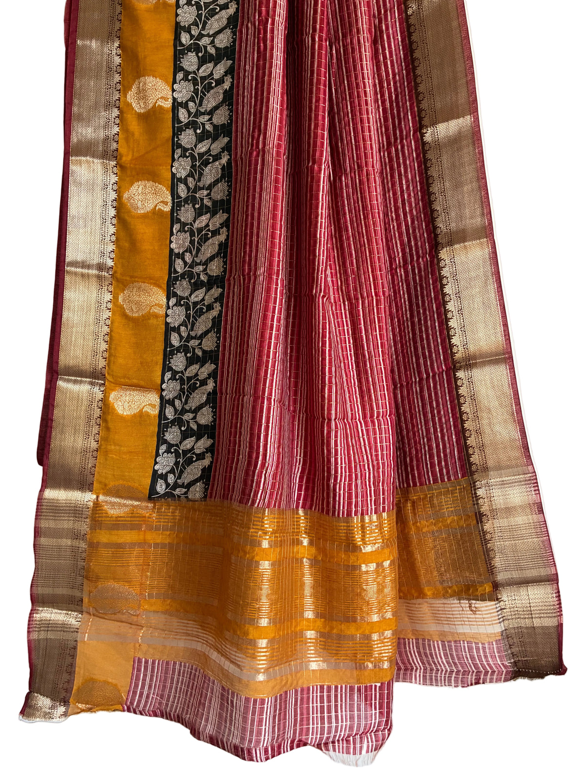Detailed view of rich Assam silk saree pallu with intricate Kalamkari floral vines and broad gold border