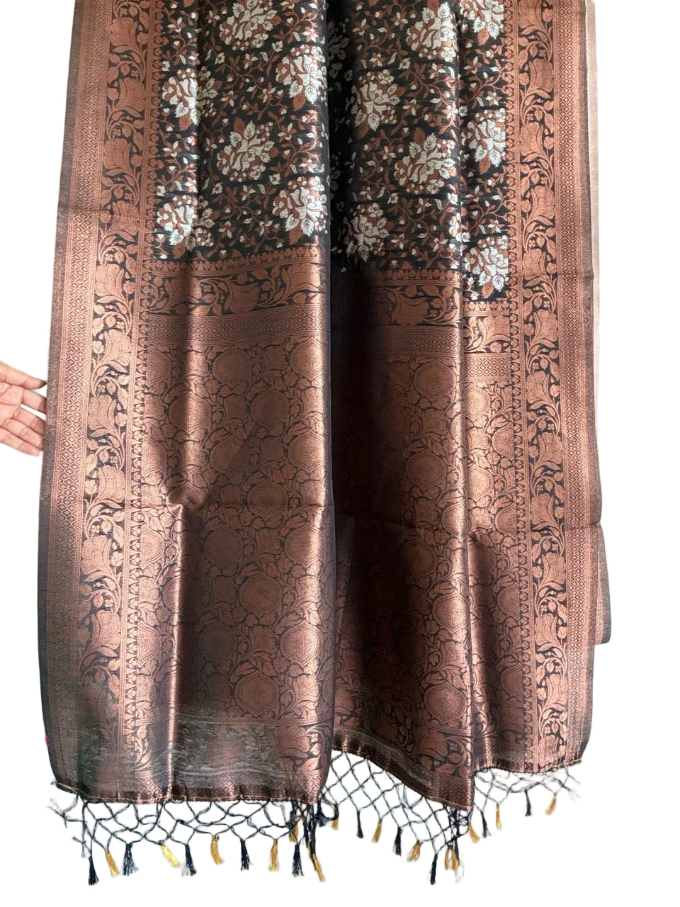 Detailed view of rich black saree statement pallu with copper weave and tasselled ends