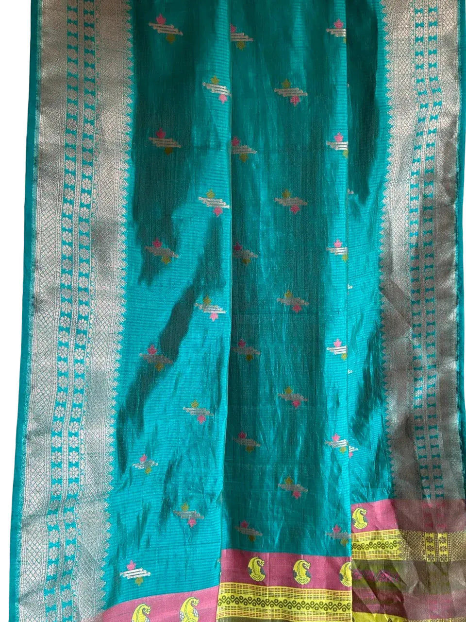 Close up of soft breathable blue saree weave featuring fine border detailing and rich contrast accents