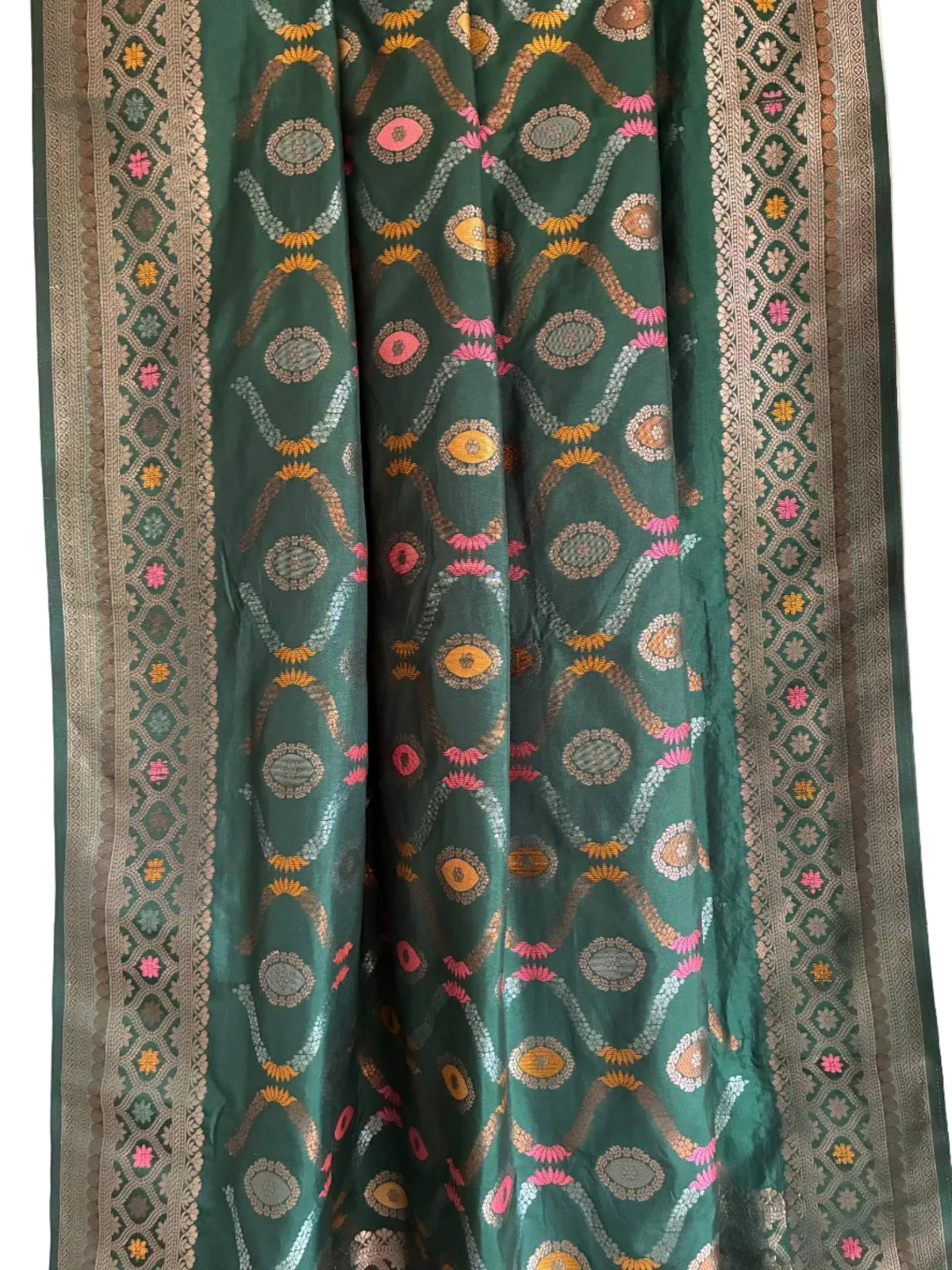 Close up of soft breathable green silk weave featuring intricate floral vine patterns and metallic border