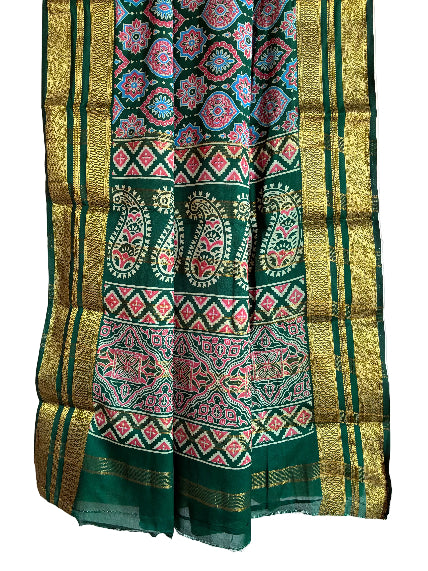 Detailed view of rich green modal silk saree pallu with bold paisleys and patterned bands