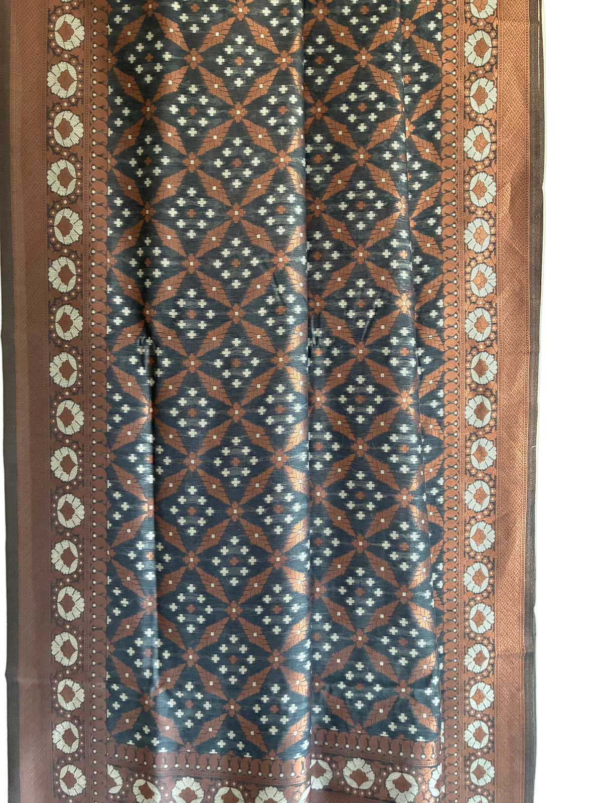 Close up of soft breathable charcoal grey metallic fabric featuring copper motifs and ornate silver border