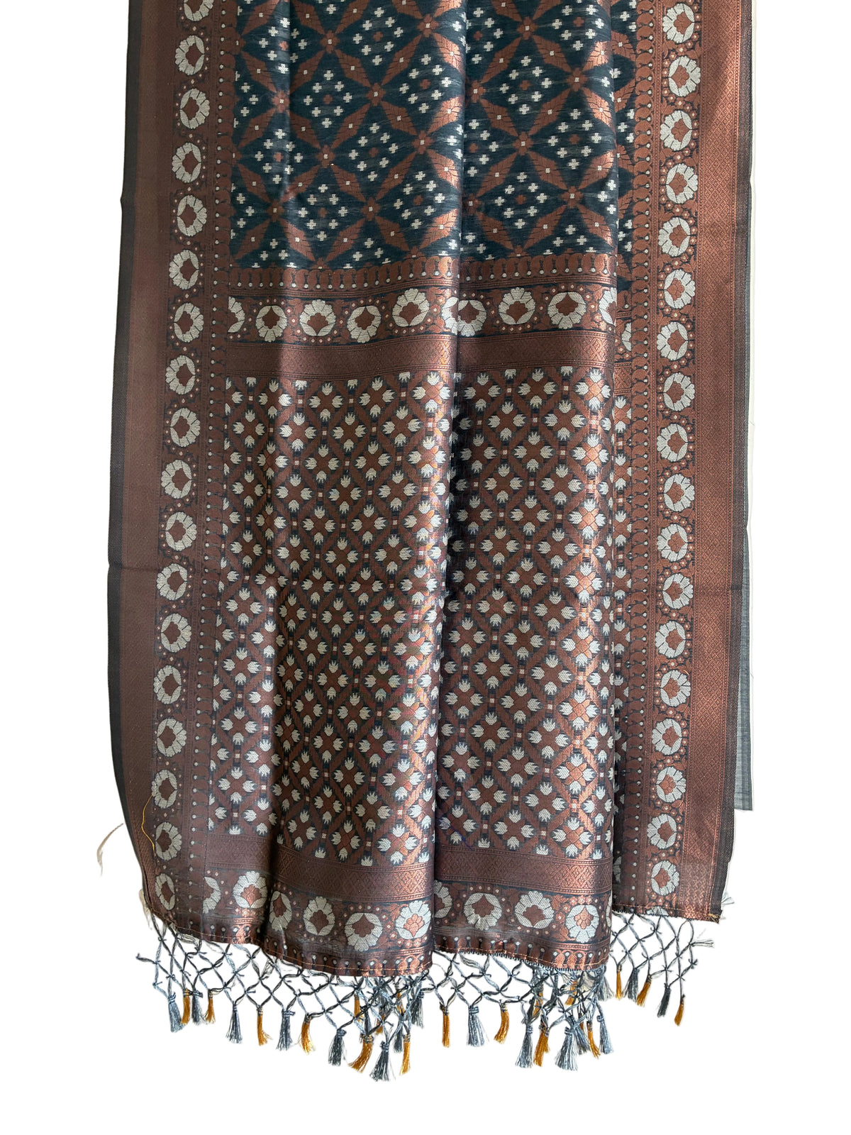 Detailed view of elaborate charcoal grey saree pallu with copper lattice weave and knotted tassels