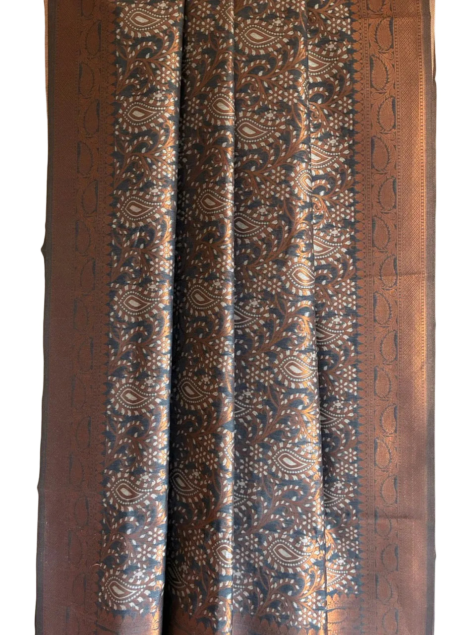 Close up of soft breathable grey fabric with delicate copper floral detailing and broad ornamental border