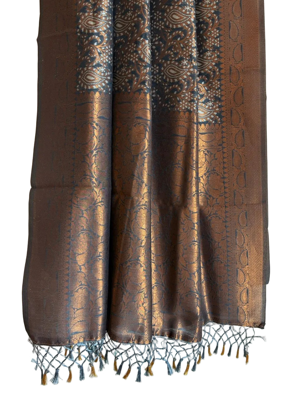 Detailed view of richly patterned grey saree pallu with metallic copper weave and knotted tassels