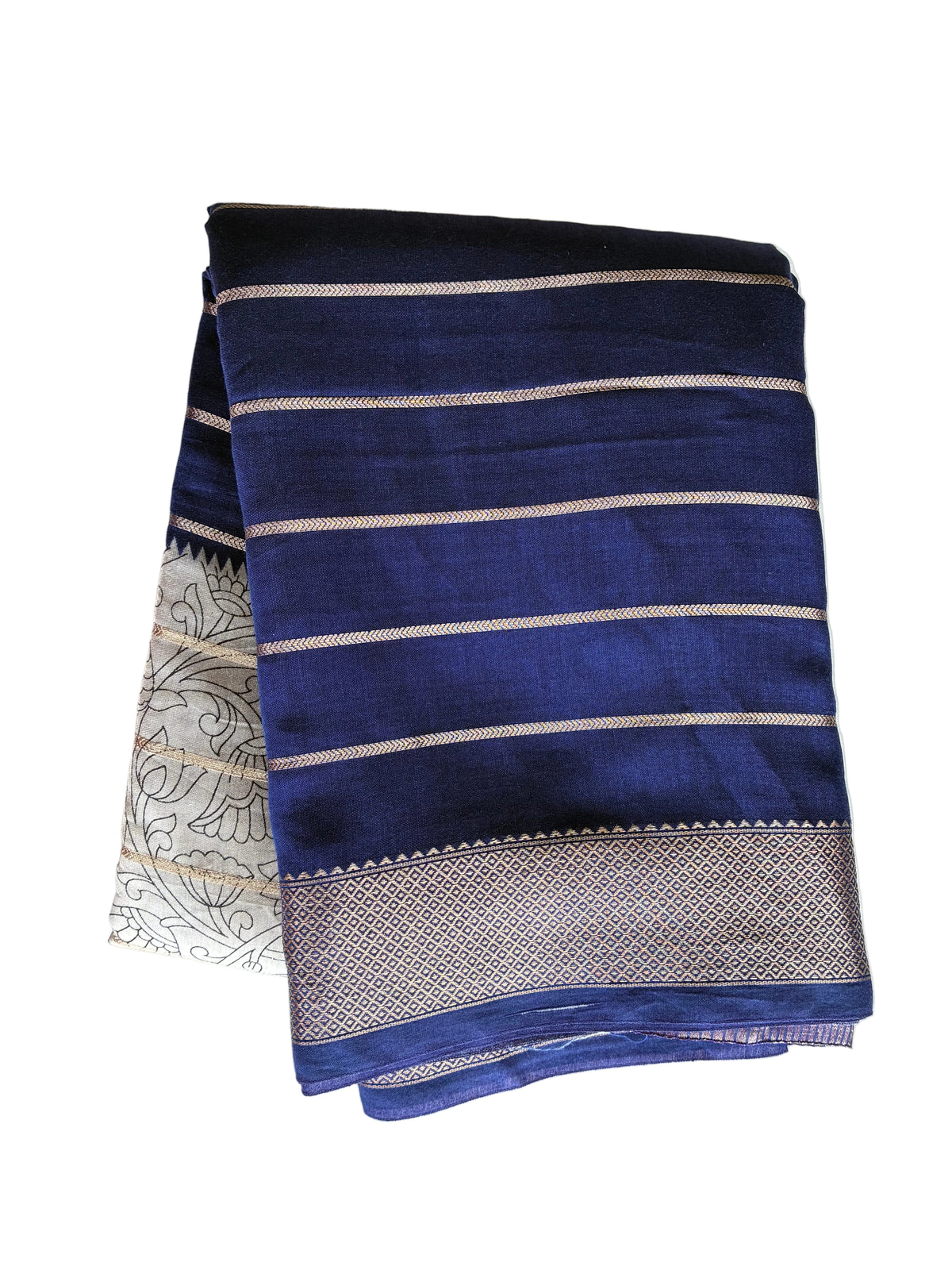 Neatly folded royal blue Kalamkari print saree showing fine gold stripes and lustrous golden border detail