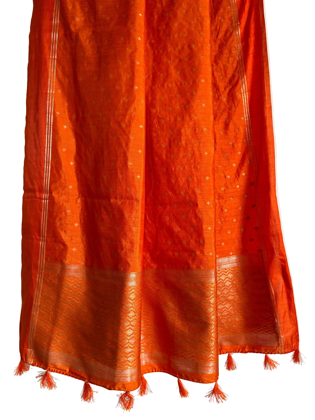 Detailed view of vibrant orange jute silk saree pallu styled for festive wear