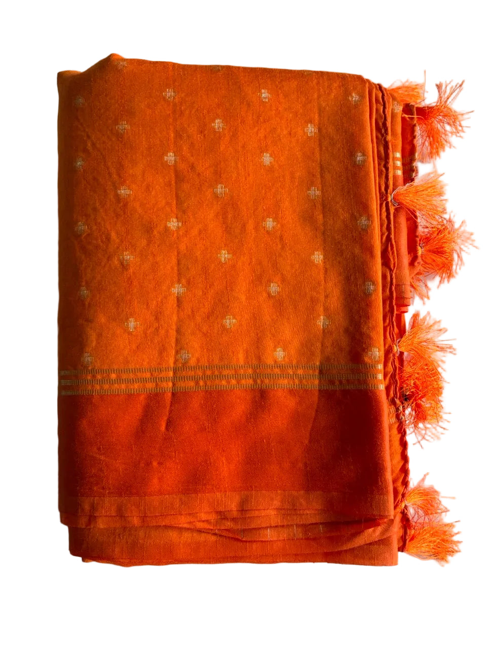 Neatly folded light comfortable bright orange jute silk saree displaying texture detail
