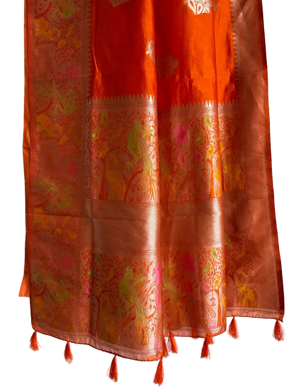 Detailed view of rich orange saree pallu with pink and green accents and orange tassels