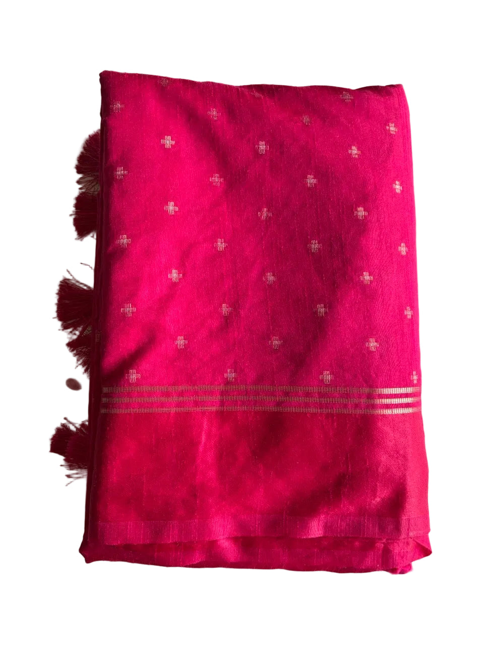 Neatly folded light comfortable bright pink jute silk saree showcasing rich color and weave