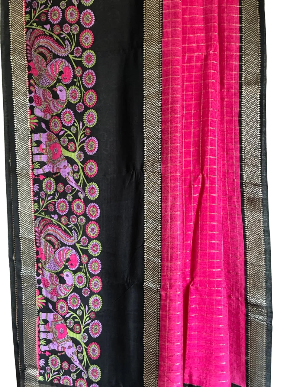 Close up of soft breathable pink saree fabric featuring intricate Kalamkari motifs and black accents
