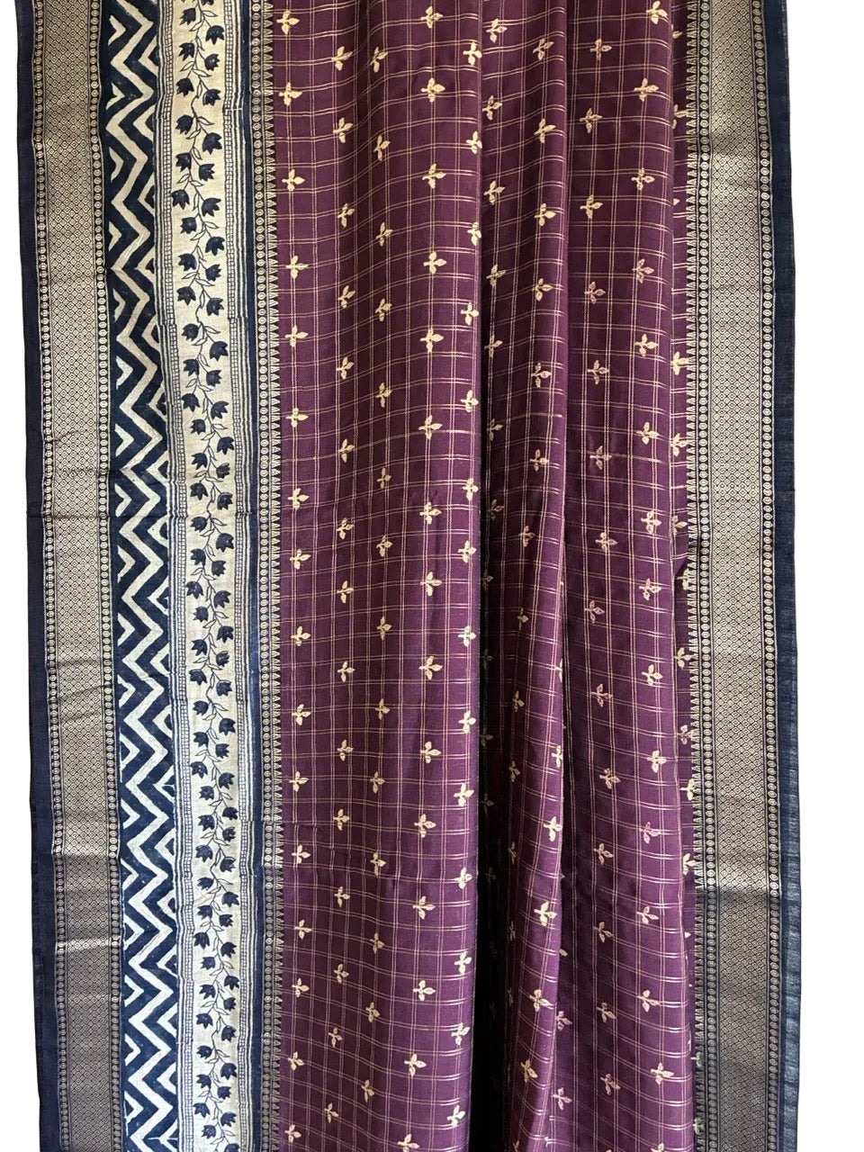 Close up of soft breathable purple checked fabric featuring gold motifs chevron border and floral vines