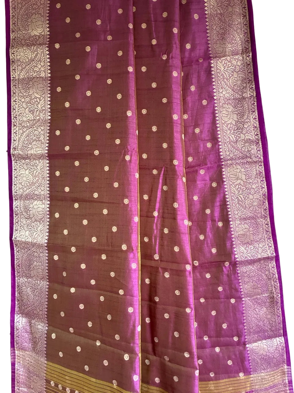 Close up of soft breathable purple saree fabric with delicate gold butti work and detailed border