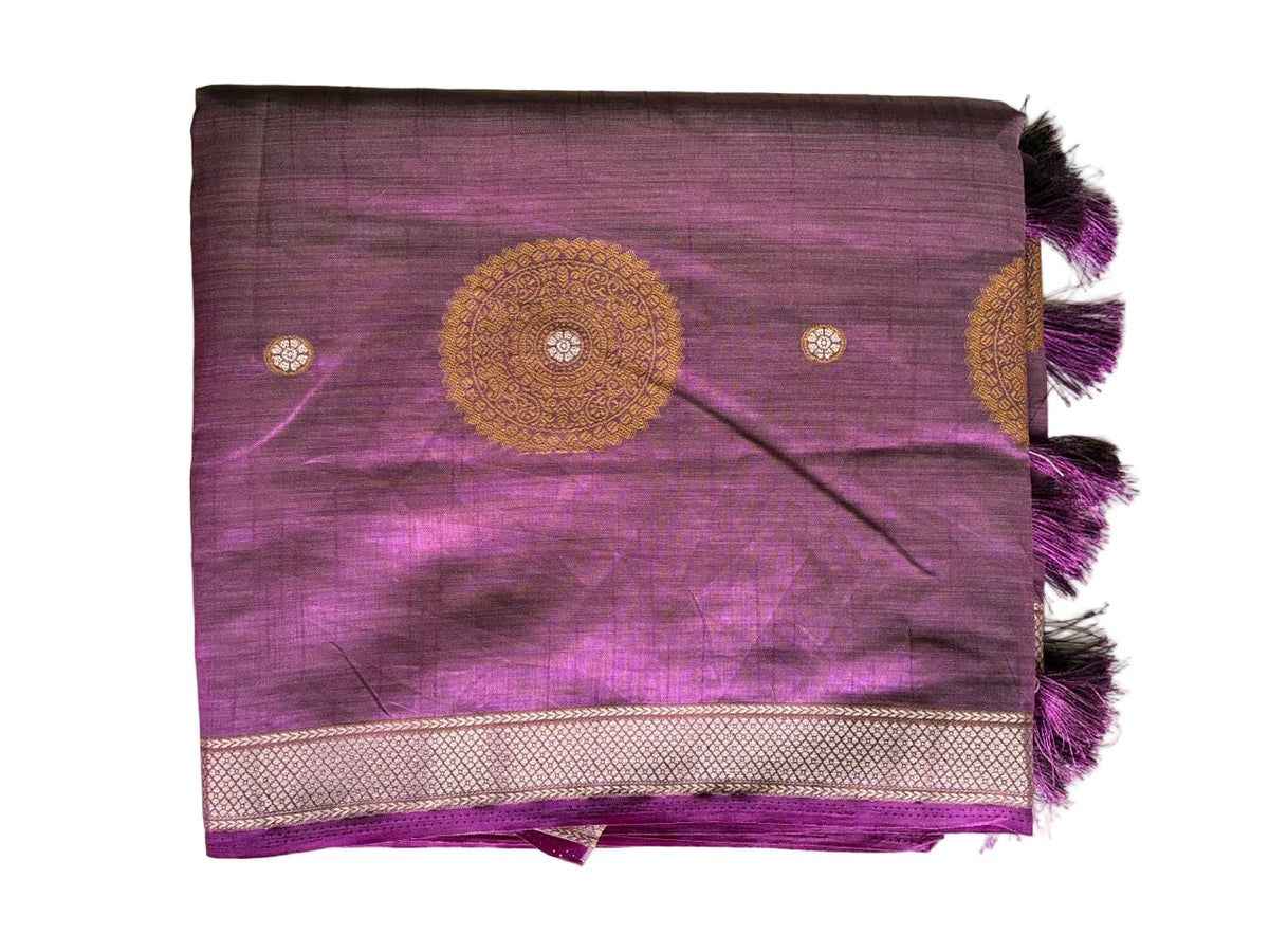 Neatly folded light comfortable radiant purple saree showing gold mandala patterns and tassel detail