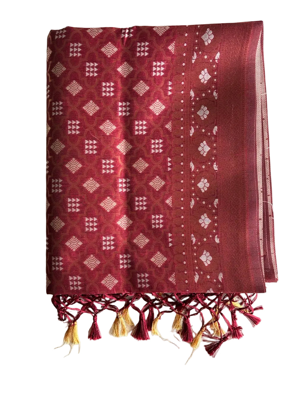 Neatly folded light comfortable red Banarasi style saree displaying gold geometric motifs and floral border