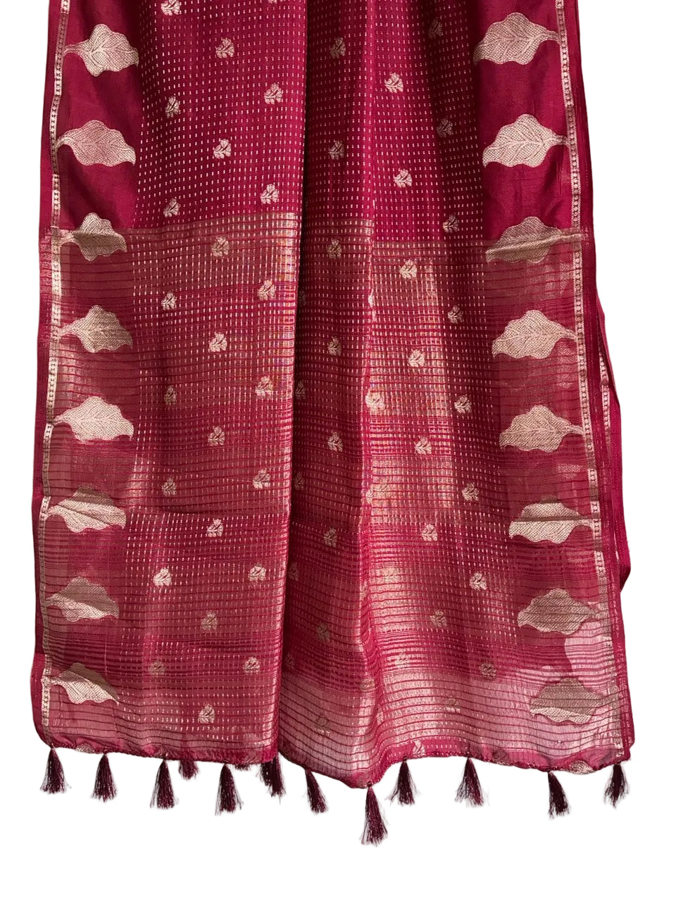 Detailed view of shimmering striped red saree pallu with gold weave and matching red tassels