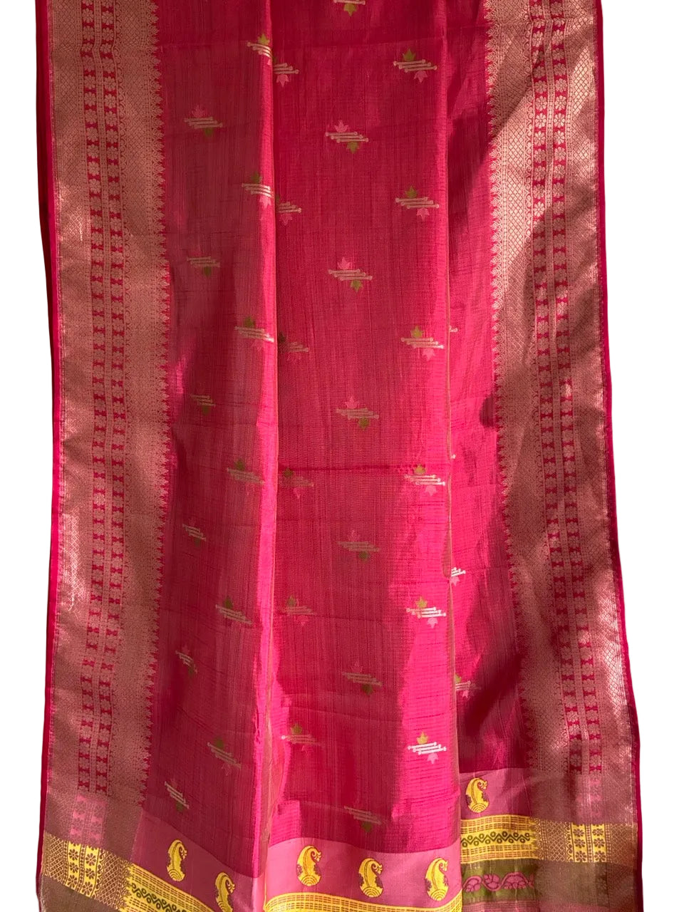 Close up of soft breathable red saree weave featuring fine border detailing and rich contrast accents